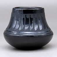A black on black jar decorated with a ring of feathers design above the shoulder, click or tap to see a larger version