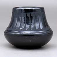 A black on black jar decorated with a ring of feathers design above the shoulder, click or tap to see a larger version