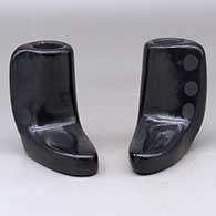 A pair of black candlestick holders
 by Blue Corn of San Ildefonso