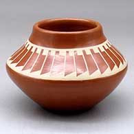 A buff on red jar decorated with a band of feathers geometric design above the shoulder
 by Kathy Gutierrez of San Ildefonso