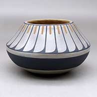 A polychrome jar decorated above the shoulder with a band of feathers geometric design
 by Blue Corn of San Ildefonso