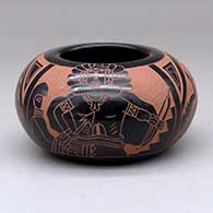 A red-and-black bowl decorated with a four-panel sgraffito dancer, feather, avanyu and geometric design
 by Tom Tapia of Ohkay Owingeh