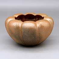A golden micaceous melon bowl with fire clouds and eight repousse ribs
 by Angie Yazzie of Taos