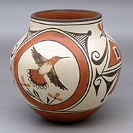 A polychrome jar decorated with a four panel hummingbird, rainbow,flower and geometric design
 by Marcellus Medina of Zia