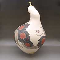 A large, lidded sculptural piece decorated with a lightly carved, sgraffito and painted flower, serpent and geometric design, click or tap to see a larger version