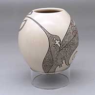 A polychrome jar decorated with a hummingbird, flower and fine line design
 by Carla Martinez of Mata Ortiz and Casas Grandes