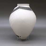 A polychrome jar with a geometric cut rim and decorated with a sgraffito and painted tiny square and geometric design, click or tap to see a larger version