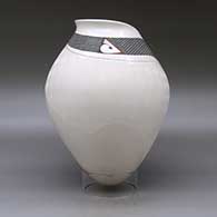 A polychrome jar with a geometric cut rim and decorated with a sgraffito and painted tiny square and geometric design, click or tap to see a larger version