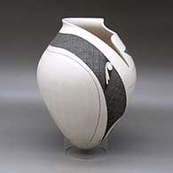 A polychrome jar with a geometric cut rim and decorated with a sgraffito and painted tiny square and geometric design, click or tap to see a larger version