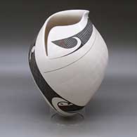 A polychrome jar with a geometric cut rim and decorated with a sgraffito and painted tiny square and geometric design
 by Diego Valles of Mata Ortiz and Casas Grandes