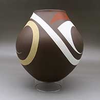 A large polychrome jar decorated with a three panel tiny square, sickle and flowing geometric design, click or tap to see a larger version