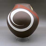 A large polychrome jar decorated with a three panel tiny square, sickle and flowing geometric design, click or tap to see a larger version
