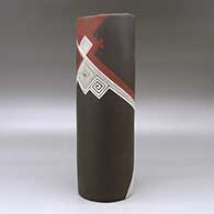 A tall polychrome cylinder decorated with a spiral and fineline flowing geometric design, click or tap to see a larger version