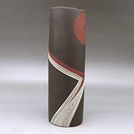 A tall polychrome cylinder decorated with a spiral and fineline flowing geometric design, click or tap to see a larger version