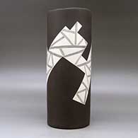 A white on brown cylinder with an organic rim and decorated with a fineline and geometric design, click or tap to see a larger version