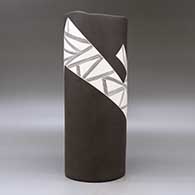 A white on brown cylinder with an organic rim and decorated with a fineline and geometric design, click or tap to see a larger version