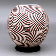 A polychrome jar decorated with a four panel geometric design, click or tap to see a larger version