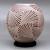 A polychrome jar decorated with a four panel geometric design, click or tap to see a larger version