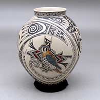 A polychrome jar with a flared rim and decorated with a bird, lizard, insect and geometric design
 by Manuel Rodriguez of Mata Ortiz and Casas Grandes