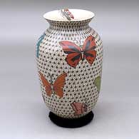 A polychrome vase with a flared lip and decorated with a butterfly and geometric design
 by Olga Arras of Mata Ortiz and Casas Grandes