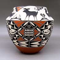 A large polychrome jar decorated with a three panel geometric design below the shoulder and a six panel deer and geometric design above the shoulder, click or tap to see a larger version
