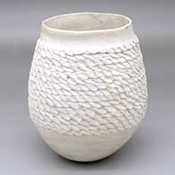 A white jar with a wide band of corrugation around and above the shoulder
 by Marie Z Chino of Acoma