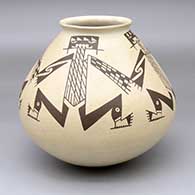 A brown-on-tan jar with a flared rim and a painted four-panel Mimbres lizard-man geometric design
 by Juan Quezada Sr of Mata Ortiz and Casas Grandes