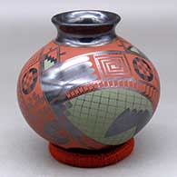 A glossy black jar with a rolled lip decorated with a three panel red and black geometric design
 by Gerardo Pedregon of Mata Ortiz and Casas Grandes