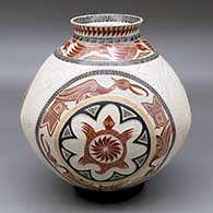 A polychrome jar with a recurved lip and decorated with a lightly carved, sgraffito and painted three panel turtle, bird, lizard and geometric design
 by Eleuterio Pina of Mata Ortiz and Casas Grandes