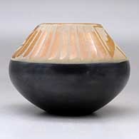 A black and sienna jar decorated with a feather and geometric design above the shoulder, click or tap to see a larger version