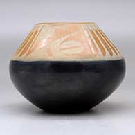 A black and sienna jar decorated with a feather and geometric design above the shoulder, click or tap to see a larger version