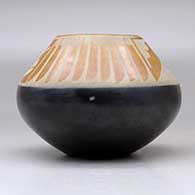 A black and sienna jar decorated with a feather and geometric design above the shoulder, click or tap to see a larger version