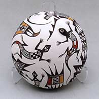 A polychrome seed pot decorated with a lizard head applique and decorated with a lizard and geometric design
 by Carolyn Concho of Acoma