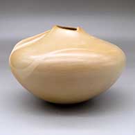 A buff seed jar with an organic opening, an ear of corn applique and her matte Breath of Life design, click or tap to see a larger version