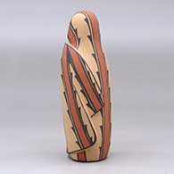 A polychrome Singing Mother wearing a manta decorated with a geometric design, click or tap to see a larger version