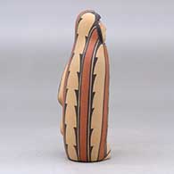 A polychrome Singing Mother wearing a manta decorated with a geometric design, click or tap to see a larger version