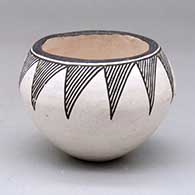 A small black on white bowl decorated with a geometric design around the shoulder
 by Lucy Lewis of Acoma