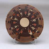 A polychrome round tile decorated with a Night Chant Dancers design
 by Ida Sahmie of Dineh