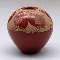 A red seed pot decorated above the shoulder with a sgraffito family of quail
 by Goldenrod of Santa Clara