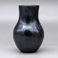 A black vase carved with two bear paw imprints, click or tap to see a larger version