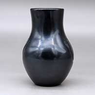 A black vase carved with two bear paw imprints, click or tap to see a larger version