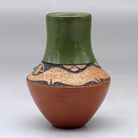 A small polychrome vase with a sgraffito and micaceous clay avanyu design above the shoulder with an inlaid turquoise, click or tap to see a larger version