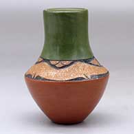A small polychrome vase with a sgraffito and micaceous clay avanyu design above the shoulder with an inlaid turquoise, click or tap to see a larger version