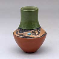 A small polychrome vase with a sgraffito and micaceous clay avanyu design above the shoulder with an inlaid turquoise
 by Russell Sanchez of San Ildefonso