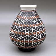 A polychrome jar with a rolled lip and decorated with a geometric design
 by Arturo Ledezma of Mata Ortiz and Casas Grandes