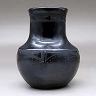 A black on black water jar decorated with bands of geometric design around the shoulder and around the upper neck, click or tap to see a larger version