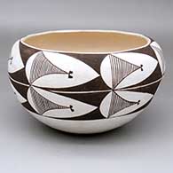 A black-on-white bowl decorated with a seven-panel fine line and geometric design
 by Emmalita Chino of Acoma