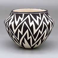 A black-on-white jar decorated with a lightning bolt design
 by Lucy Lewis of Acoma