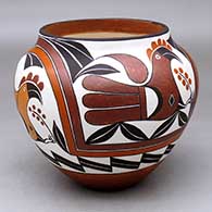 A polychrome jar decorated with a four-panel parrot, rainbow, flower and geometric design from about 1885
 by Lilly M Salvador of Acoma