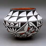 A polychrome jar decorated with a four panel geometric design
 by Eva Histia of Acoma
